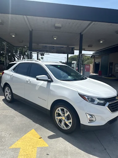 White Chevrolet Equinox under wash canopy at Images Auto Spa Altamonte Springs