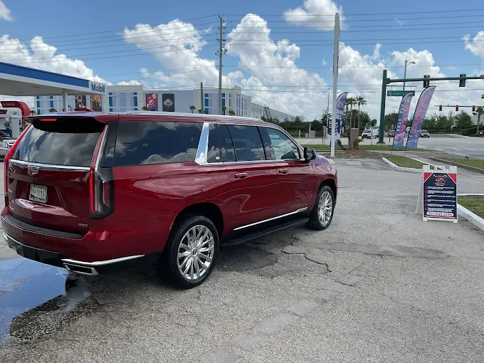 Red Cadillac Escalade after detailing at AJS Auto Spa