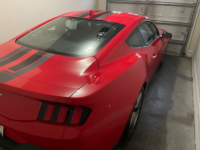Red Mustang being detailed inside Bullseye Auto Spa