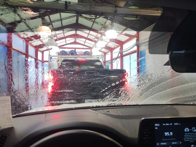 Vehicle inside DLuxe Hand Car Wash automatic wash bay