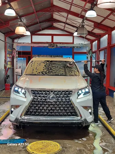White Lexus SUV being washed at DLuxe Hand Car Wash