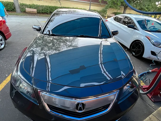 Freshly hand washed black Acura sedan at DLuxe Hand Car Wash in Orlando