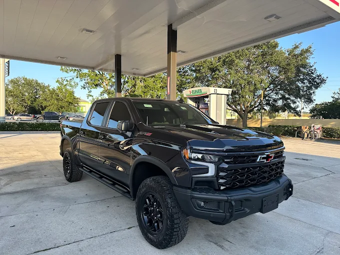 Black Chevrolet Silverado truck after detailing at DLuxe Hand Car Wash