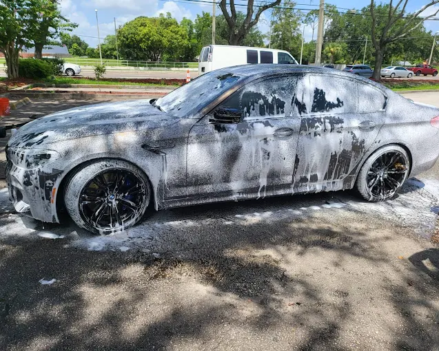 Foam hand wash on black sedan