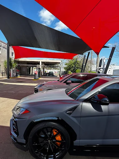 Gray performance SUV under canopy at Images Auto Spa