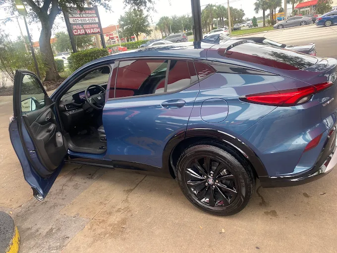 Blue SUV with open door after cleaning at Images Auto Spa