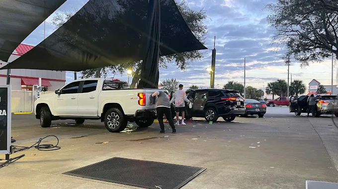 White pickup truck under canopy at Images Auto Spa
