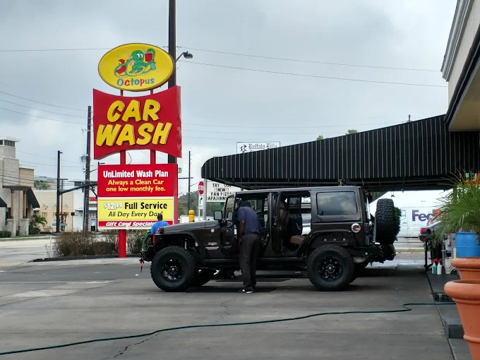 Jeep Wrangler parked by Octopus Car Wash sign in Orlando