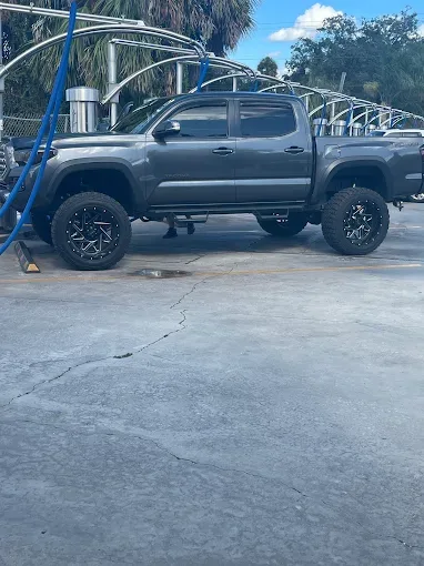Gray pickup truck in vacuum area at Octopus Car Wash Plant City