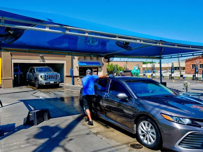 Octopus Car Wash Plant City team member hand drying a sedan