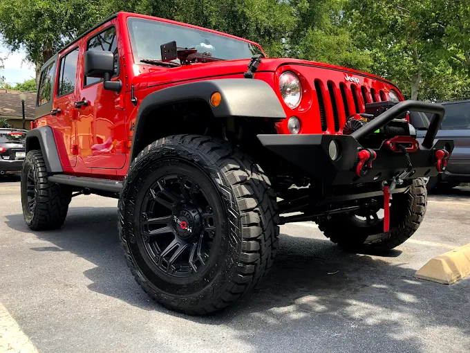 Red lifted Jeep Wrangler at Sparkling Image Car Wash Orlando