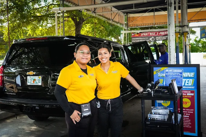Sparkling Image Car Wash team members assisting customer at full-service lane